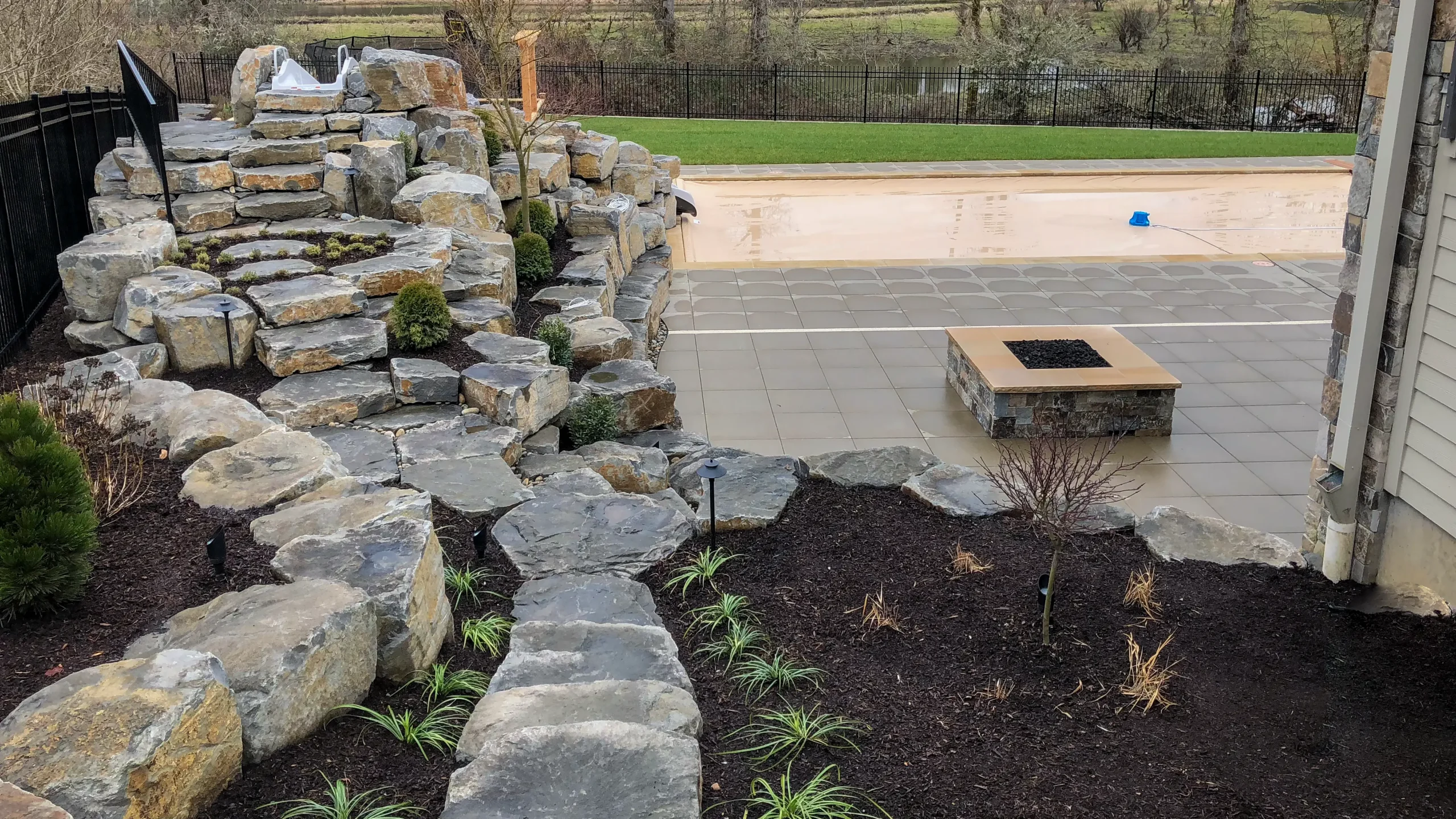 Restored stone masonry retaining wall and steps