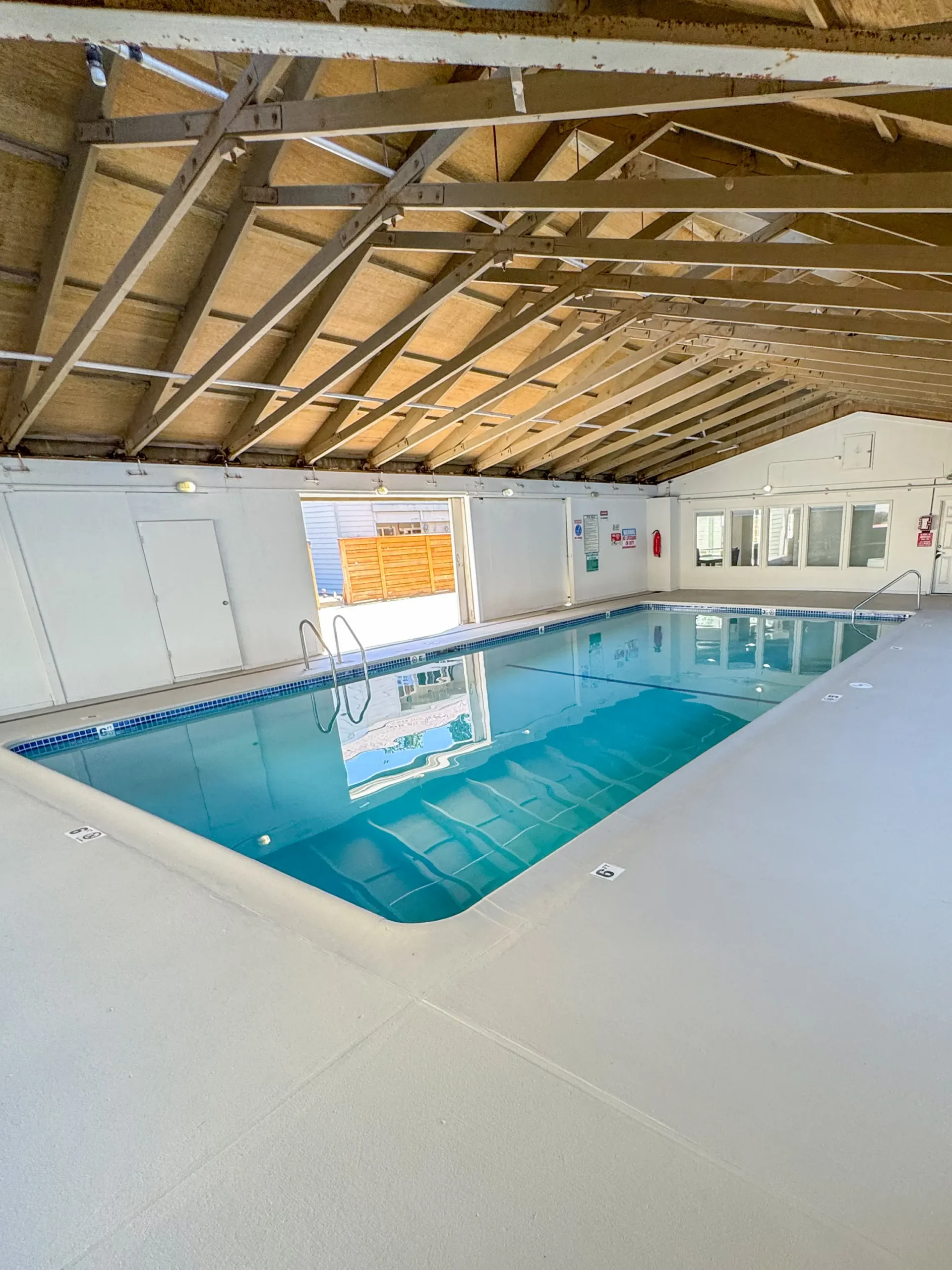 Finished rectangular pool with stone coping and pool house